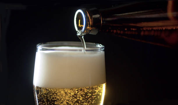 istock Beer pouring from the bottle into the glass 1205031941