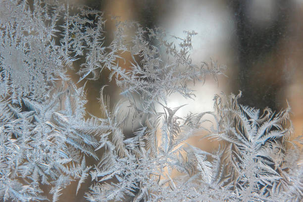istock frosty patterns on the window glass closeup. natural textures and backgrounds. ice patterns on frozen 1205036595