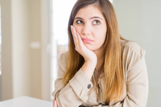 istock Beautiful young woman at home thinking looking tired and bored with depression problems with crossed arms. 1205036764