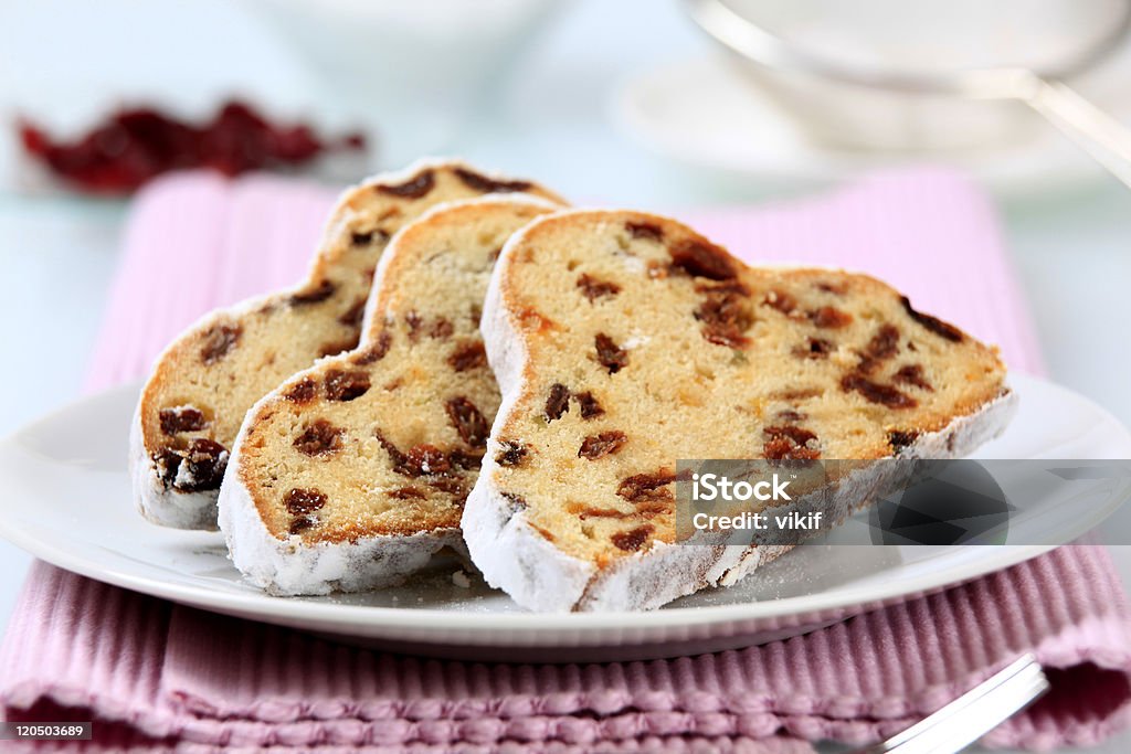 Close-up of three slices of stollen served on a white plate Slices of stollen with raisins and candied fruit Stollen Stock Photo