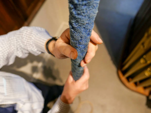 Bell ringer at work in his local church An adult senior man, ringing a bell in his local church to notify people that a service is about to begin. He is holding on to the blue woollen handle on the rope known as the sally and pulling it downwards to enable the bell to ring out. The rope below the sally is called the tail and is pulled in a secondary motion. ringer stock pictures, royalty-free photos & images