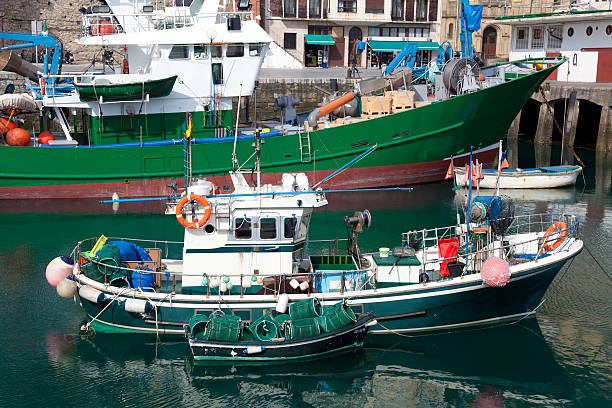 Foz, Spain- May 28, 2020: Two fishing boats mooring, Foz, A Mariña touristic area, Lugo province,  fishing harbor, Galicia, Spain.