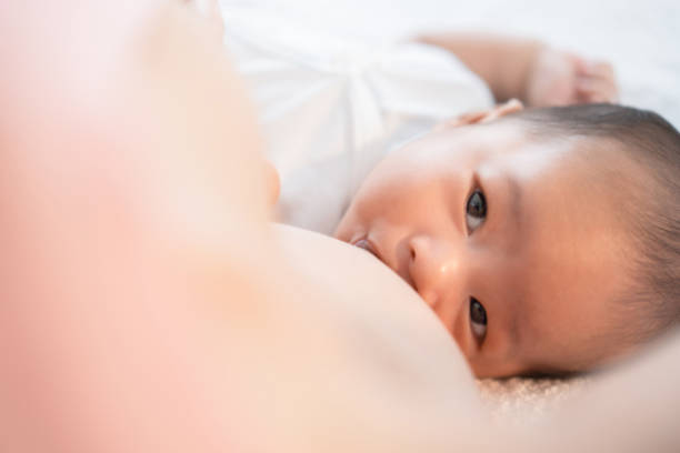 istock Newborn baby sucking breast milk 1205039838