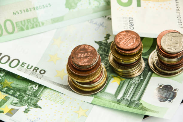istock Euro coins on banknote money background 1205042452