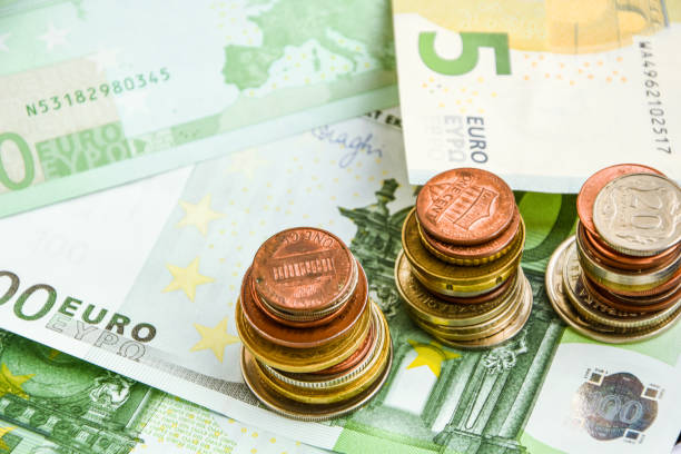 istock Euro coins on banknote money background 1205042456