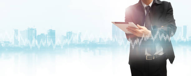 istock Businessman using tablet analyzing sales data and economic growth graph chart. Business strategy. 1205052989