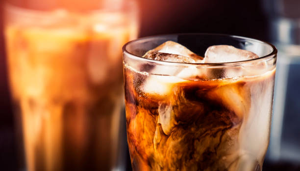 istock Summer cold coffee with ice and milk, brown background, selective focus and shallow DOF 1205056394