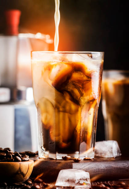 istock Summer cold coffee with ice and milk, brown background, selective focus and shallow DOF 1205056400