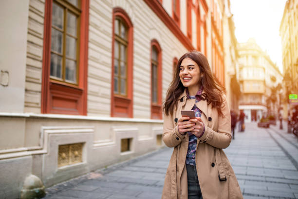 istock Young woman texting while enjoying a day. 1205056518