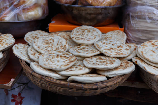 Lhasa, Tibet / China - August 1, 2017: Bowl with traditional tibetan flatbread - known as Balep Korkun. Similar to Naan. Main ingredients of the flat bread are barley flour, water and baking powder.