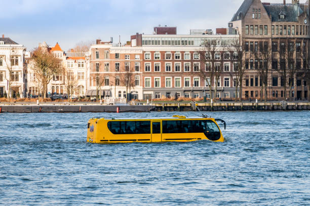 Attraction in Rotterdam, an amphibious vehicle in the river "de nieuwe Maas" Attraction in Rotterdam, an amphibious vehicle in the river "de nieuwe Maas" that can travel by road and sail like a boat with the appearance of a coach or bus amphibious vehicle stock pictures, royalty-free photos & images