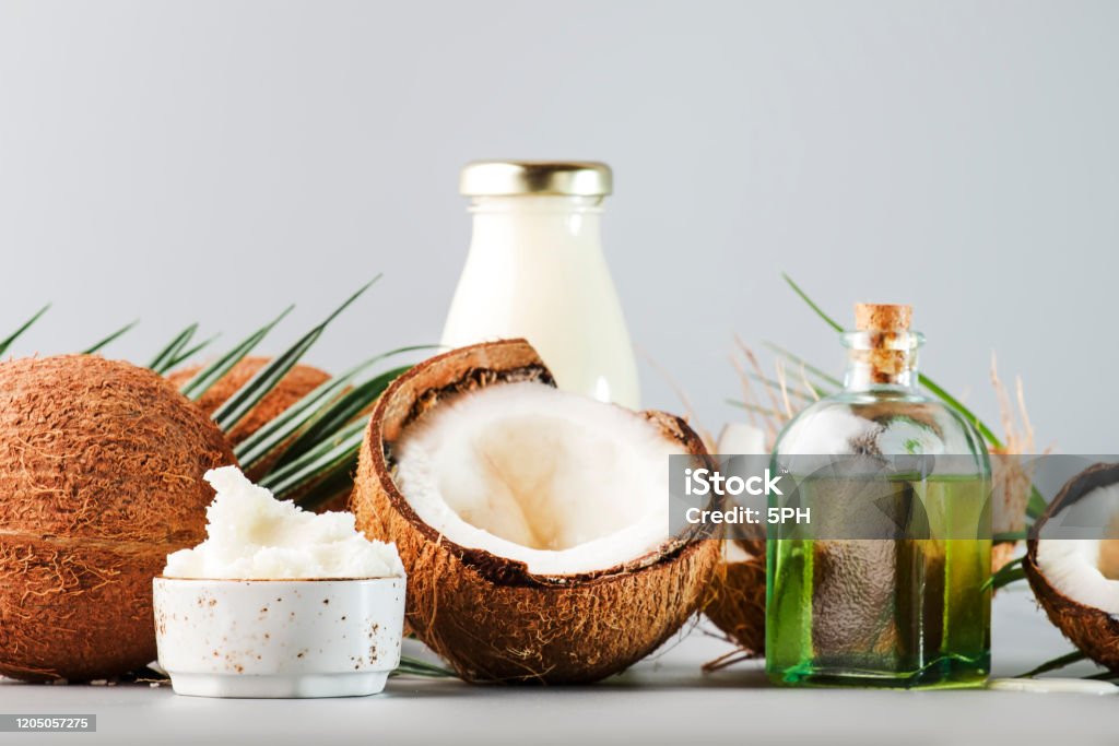 MCT Coconut butter or coconut oil. Organic healthy food, beauty and SPA concept. Gray background. Copy space Cooking Oil Stock Photo