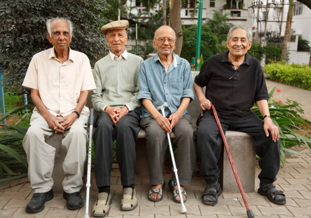 Old Indian senior men Bengaluru, India - June 25, 2010. Group of old Indian senior men relax on a park bench in Bangalore, India happiness four people cheerful senior adult stock pictures, royalty-free photos & images