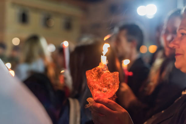 People celebration with lit candles Easter night outside Agios Minas Cathedral Heraklion, CRETE, GREECE - 28 APRIL 2019: People celebration with lit candles Easter night outside Agios Minas Cathedral orthodox church easter stock pictures, royalty-free photos & images