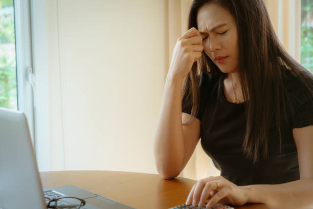 istock Stressed tired female worker  headache, taking break from work. Woman sitting with eyes closed, trying to relieve pain and calm down at workplace 1205061478