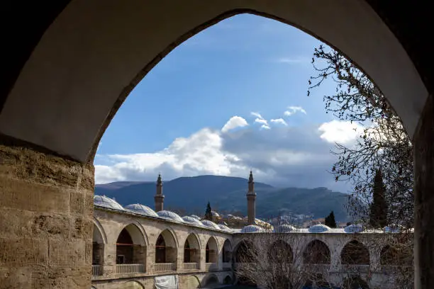 Bursa historic old  "Ulu Mosque" minarets "Pirinc Caravanserai" inn and Uludag Mountain view