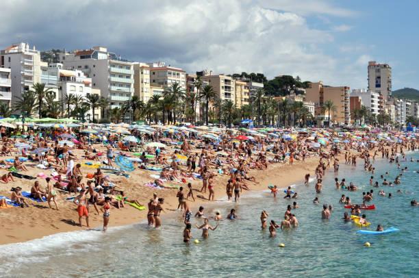 istock Crowds of people sunbathing on the beach in summer 1205063323