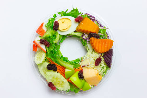 istock salad vegetable and fruit and egg top view center on white background 1205063343