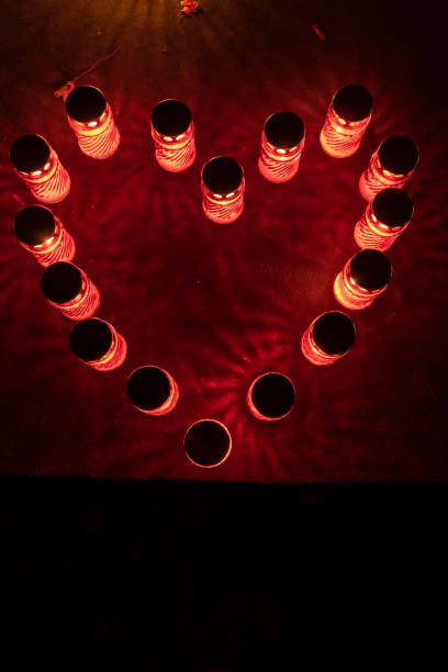 Love heart made of red candle lights illuminated at night