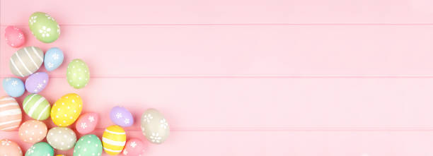 istock Easter banner with corner border of pastel Easter Eggs over a pink wood background with copy space 1205067029