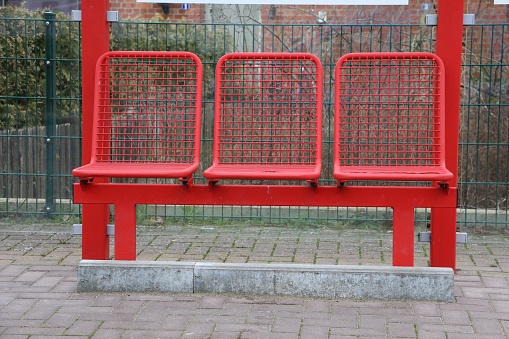 metal seats in a row at the bus stop