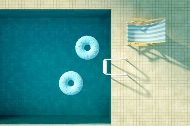 istock Summer Concept with Swimming Pool and Donuts, Aerial View 1205067698