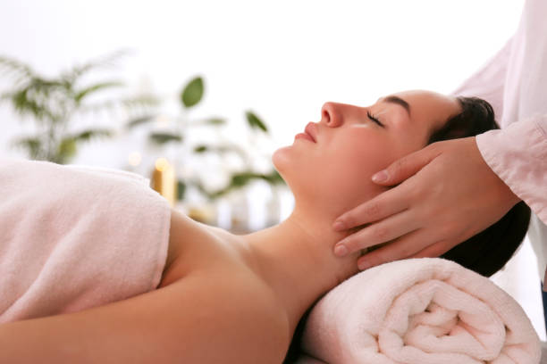 istock Brunette female with relaxed facial expression lying on a massage table. 1205068260