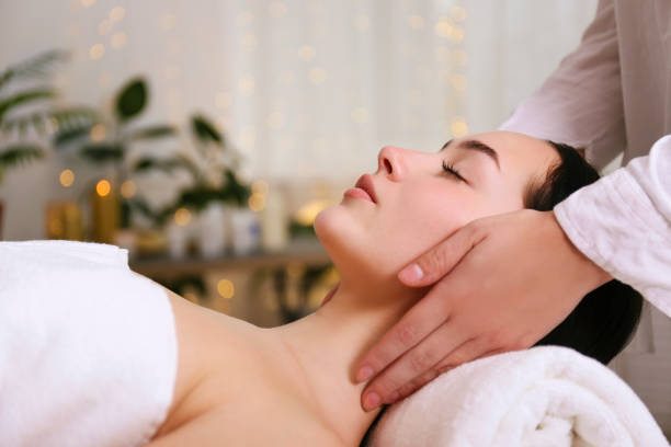 istock Brunette female with relaxed facial expression lying on a massage table. 1205068270