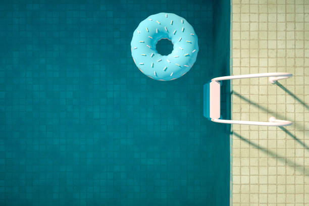 istock Summer Concept with Swimming Pool and Donuts, Aerial View 1205068286