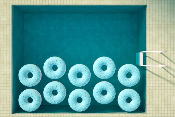 3d rendering of swimming pool and donuts. Summer Concept. Travel destinations. Aerial view. Inflatable Ring. Surreal.