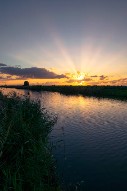 istock Sunbeams over a lake at sunset 1205068672