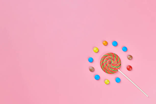 istock Sweet lollipop and candy on pink background 1205070870
