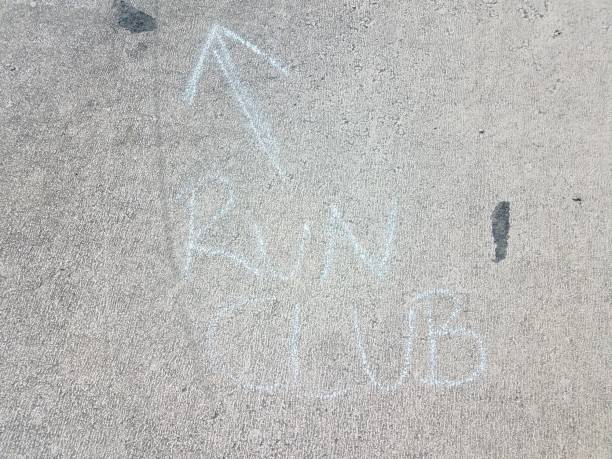 istock run club in chalk with arrow on asphalt 1205073271