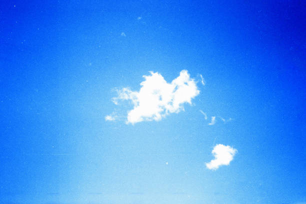 istock Grunge image of blue sky with a cloud on grainy film texture 1205074543