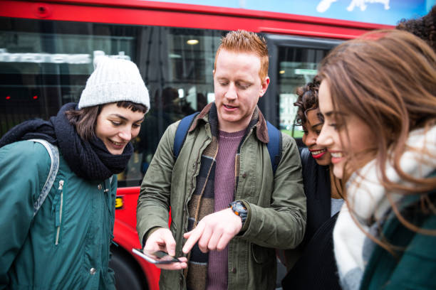 istock Friends at bus stop in London - Checking the timetable 1205076785