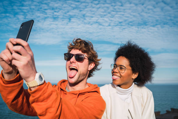 istock Two friends taking a selfie with smartpone. 1205079770