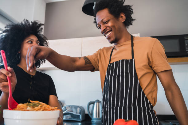 istock Afro couple cooking together in the kitchen. 1205080019
