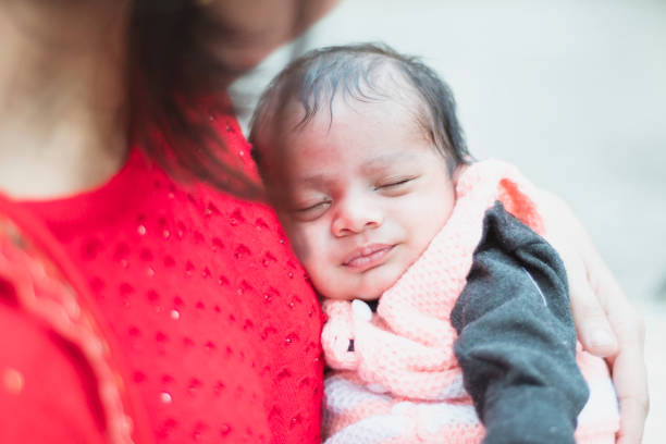 istock young mother carrying newborn baby 1205080154