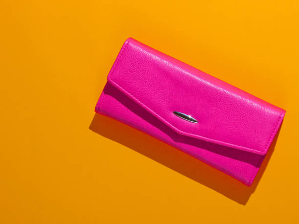 istock Pink leather wallet on yellow background. Top view 1205080724