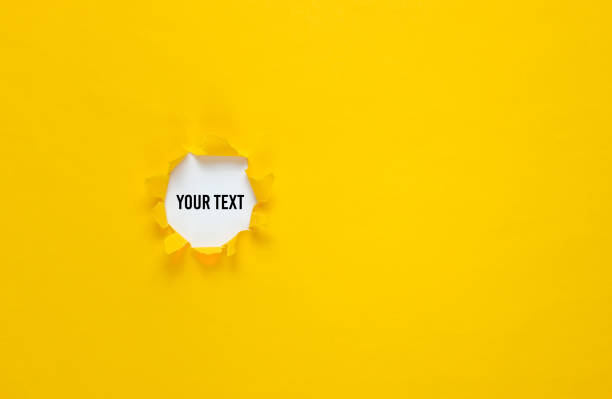 istock Torn hole in yellow paper. Top view. Minimalistic business concept. Copy space 1205084272