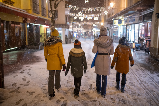 Family is enjoying sightseeing Austrian town of Zell am See in winter. Mother and kids are walking in the streets of alpine town looking at lights and shops. Beautiful snowy winter night.
Nikon D850