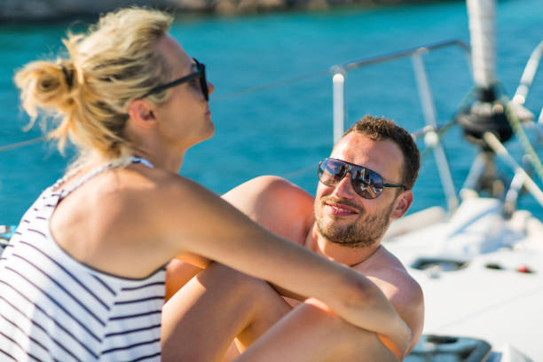 istock Couple enjoying summer at sailboat bow 1205085943