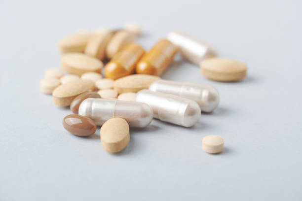 istock Multicolor vitamins and supplements on bright paper background. Concept for a healthy dietary supplementation. Close up. 1205085986
