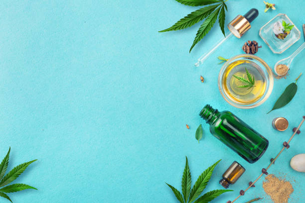 Glass bottles with CBD oil, THC tincture and hemp leaves on blue background. Flat lay, minimalism. Cosmetics CBD hemp oil. Different glass bottles with CBD OIL, THC tincture and cannabis leaves on yellow background. Flat lay, minimalism. Cosmetics CBD oil. cbd oil photos stock pictures, royalty-free photos & images