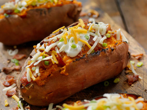 Loaded, Twice Baked Sweet Potato with Bacon, Cheese, Green Onions and Sour Cream Loaded, Twice Baked Sweet Potato with Bacon, Cheese, Green Onions and Sour Cream baked potato stock pictures, royalty-free photos & images
