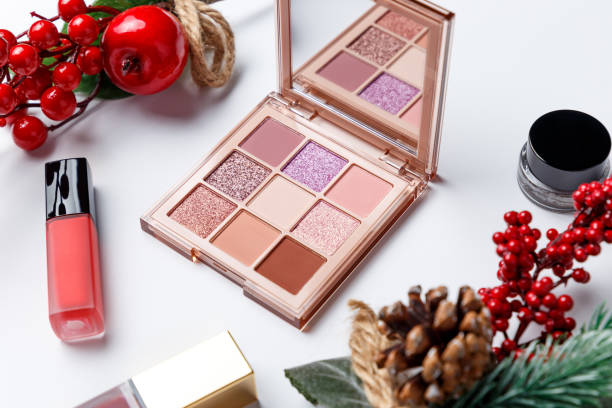 Set of professional elite decorative cosmetics for make-up on a white background with Christmas decorations. The concept of beauty and fashion. Fashion blog design. Top view. Flat lay