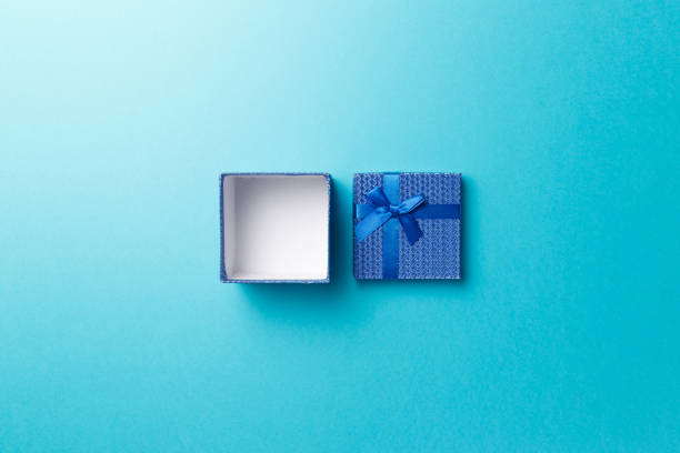 istock Blue empty gift box with blue ribbon on blue background. Top view. Flat lay. Copy space. Colorful background. Minimal christmas new year creative concept. Trendy pastel color 1205089031