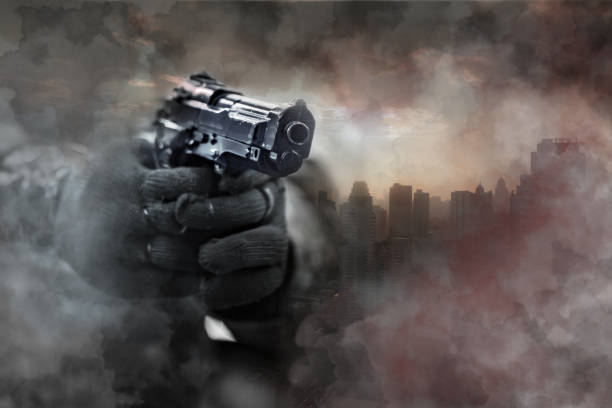 Gun in gunman's hand with city background. Gun in gunman's hand with city background. Gun-related violence concept. gunman photos stock pictures, royalty-free photos & images