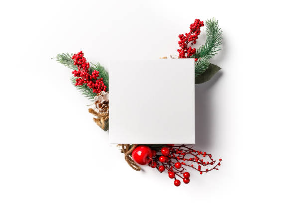 istock Christmas and new year composition. Creative layout made of paper blank on white background. Fir tree branches, red berry and decorations on white background. Winter concept. Flat lay. Copy space 1205089956