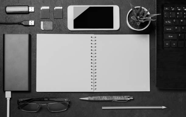 istock Electronic gadgets, succulent flower and stationery accessories on a black concrete background. Copy space 1205090746